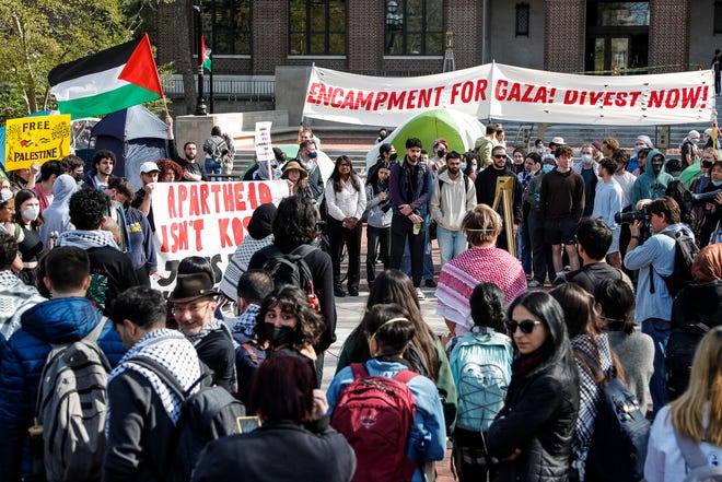 A coalition of University of Michigan students rally at an encampment in the Diag to pressure the university to divest its endowment from companies that support Israel or could profit from the ongoing conflict between Israel and the Palestinian militant group Hamas, on the University of Michigan college campus in Ann Arbor, Mich., on April 22, 2024.